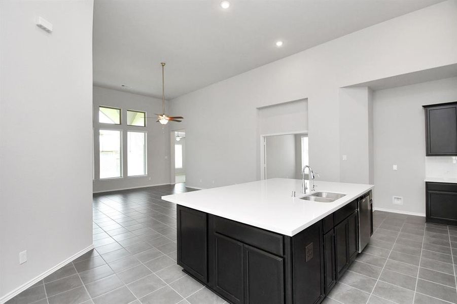 A beautifully designed kitchen featuring sleek cabinetry with convenient pot and pan drawers, complemented by the huge and luxurious island