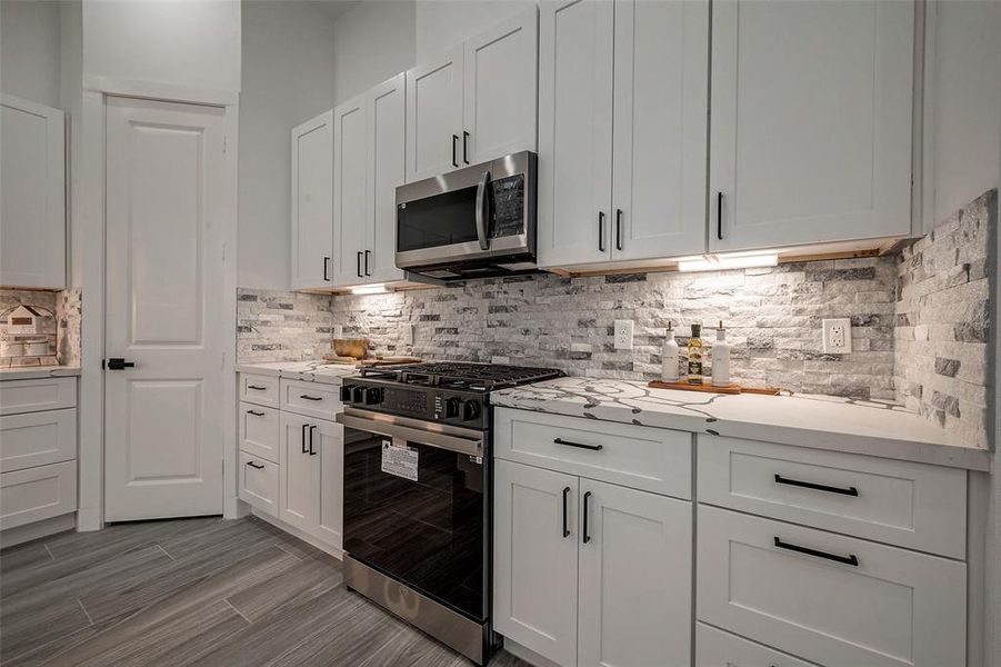No expense spared with custom upgrades in kitchen. Samsung appliances. Well lit pantry.