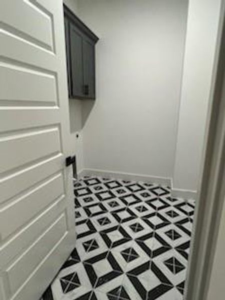 Laundry room featuring cabinets