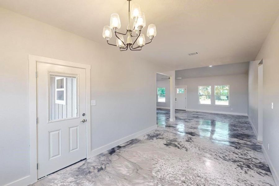 Entryway with a notable chandelier and tile patterned flooring