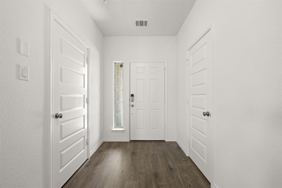 Entryway with dark hardwood / wood-style flooring