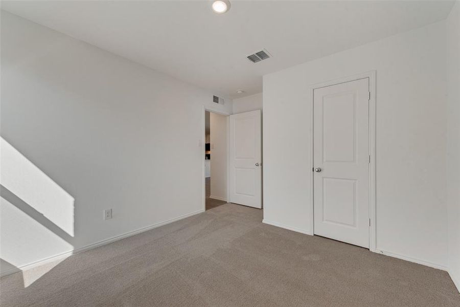 Unfurnished bedroom featuring light colored carpet