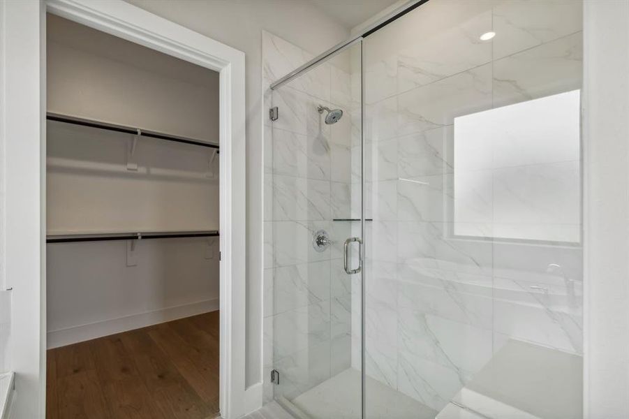 Bathroom featuring a shower with door and hardwood / wood-style floors