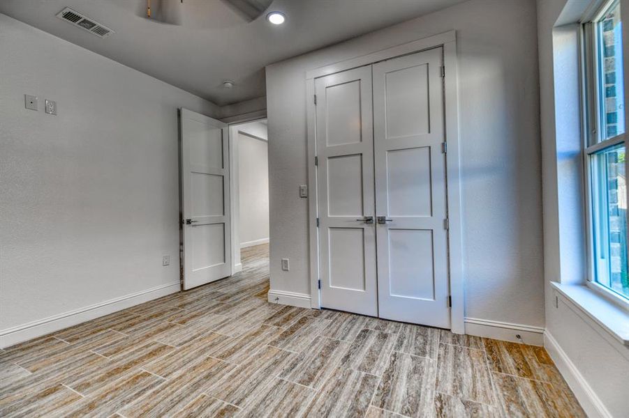 Unfurnished bedroom with light hardwood / wood-style flooring, a closet, and ceiling fan