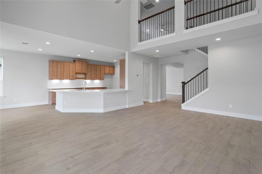 Another gorgeous view looking from the family room into the kitchen and upstairs game room.