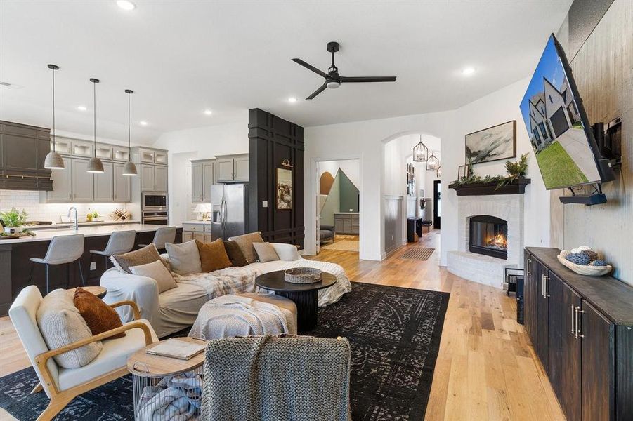 Living room with ceiling fan and light hardwood / wood-style floors