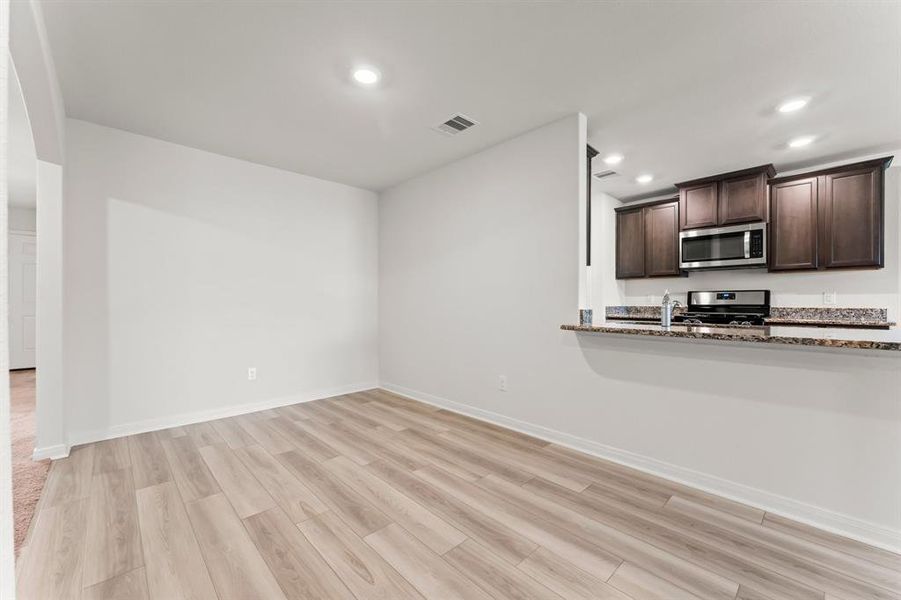 The Dining room features this easy pass-through area with the Kitchen, and the breakfast bar area can be used for casual dining.