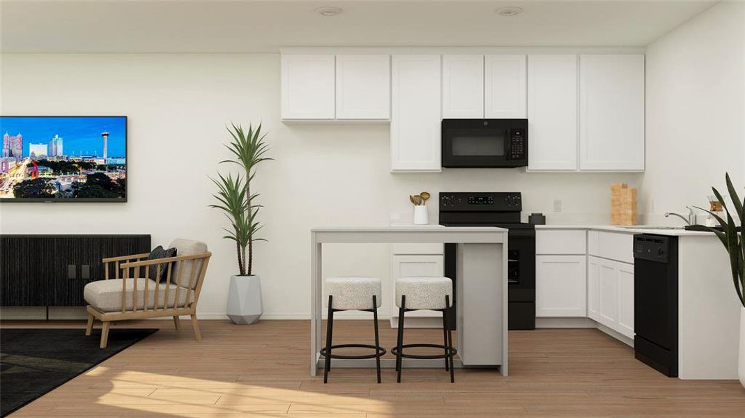 Kitchen with black appliances, light hardwood / wood-style floors, white cabinetry, and sink