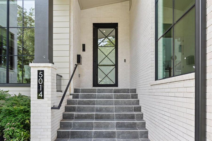 A terrific tile entryway and custom glass front door greets you upon arrival. The oversized windows throughout the home offer an abundance of natural lighting.