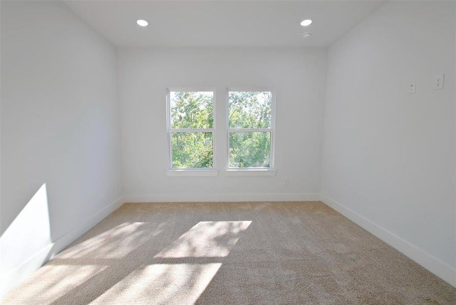 Unfurnished room featuring light carpet