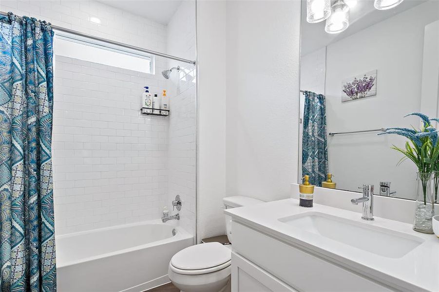 The shared full bath is conveniently located between the three secodary bedrooms and off the hall by the family room