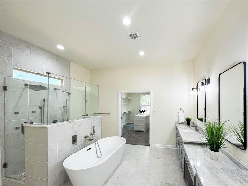 Bathroom featuring tile walls, vanity, tile flooring, and plus walk in shower