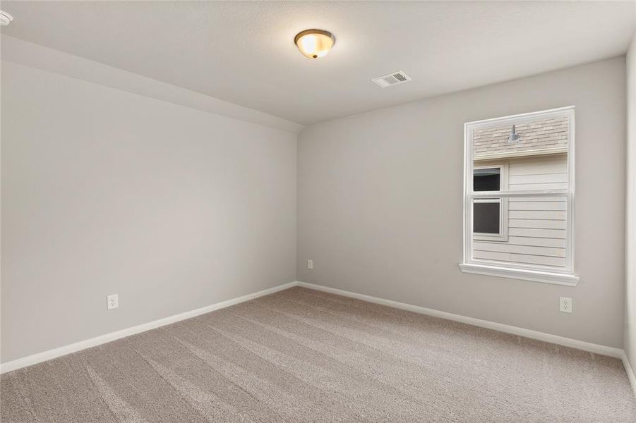 Your secondary bedroom features plush carpet, fresh paint, closet, and a large window that lets in plenty of natural lighting.