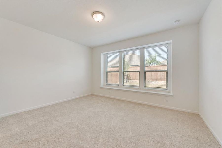 Spare room with light colored carpet