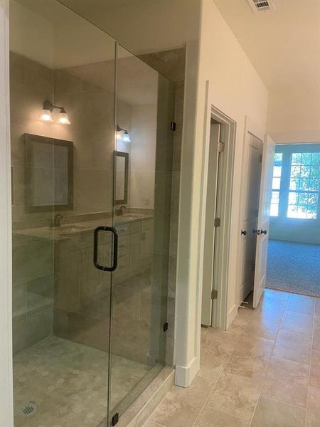 Bathroom with sink and a shower with door