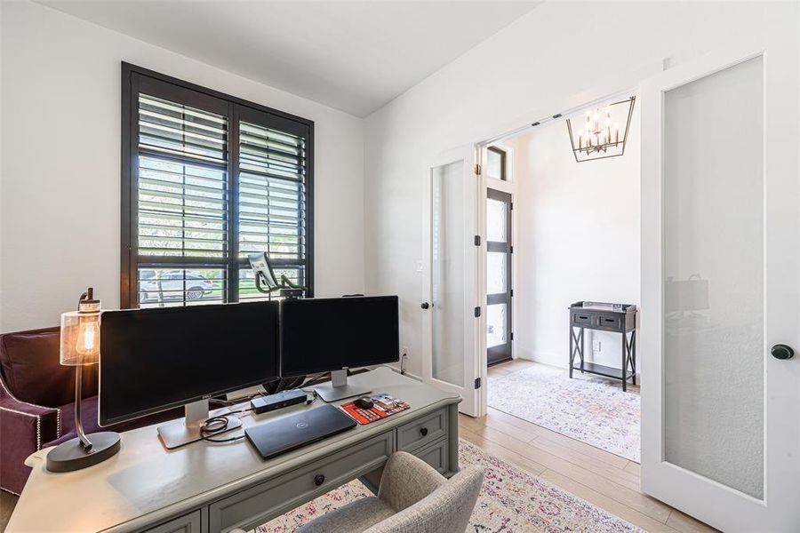 Office with double French doors and custom plantation shutters.