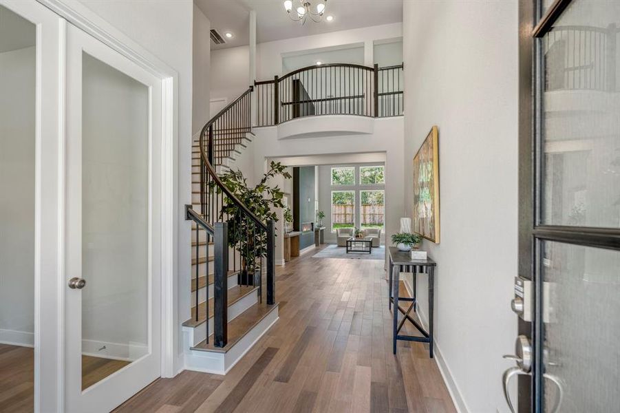 Step inside to be greeted by a grand spiral staircase and spacious living areas filled with natural light.