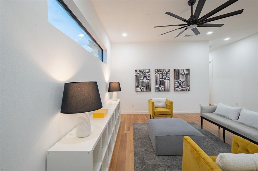 Living room featuring ceiling fan and hardwood / wood-style flooring