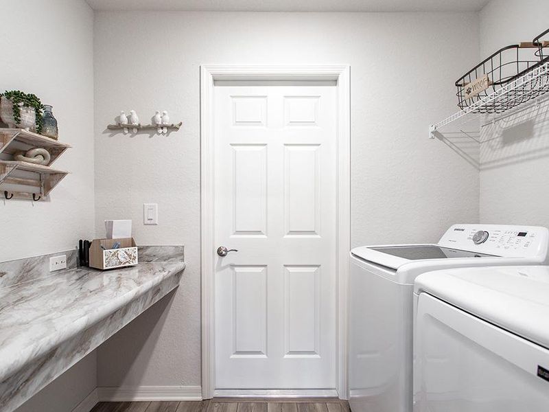 Dedicated laundry room with drop zone at the garage entry - Raychel home plan by Highland Homes