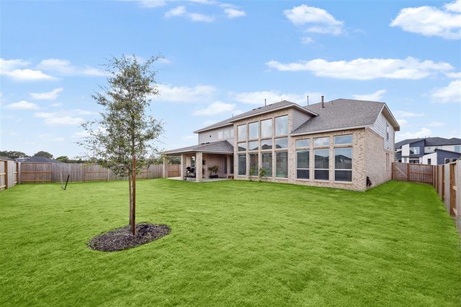 A view of the rear elevation across the spacious backyard.