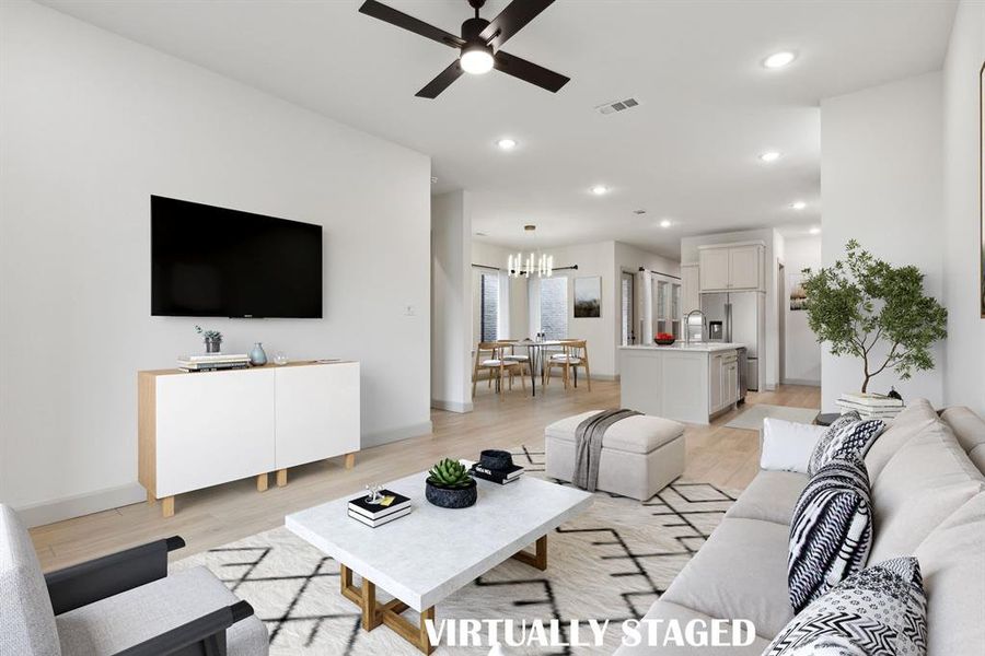 With the family room open to the kitchen and dining areas, this open concept home was made for entertaining!  VIRTUALLY STAGED