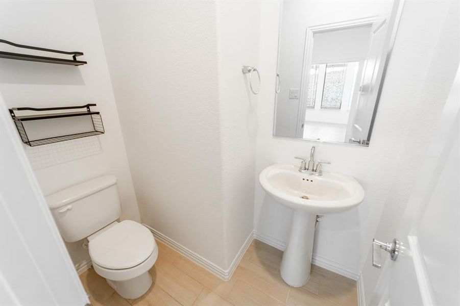 Bathroom with toilet and tile patterned floors