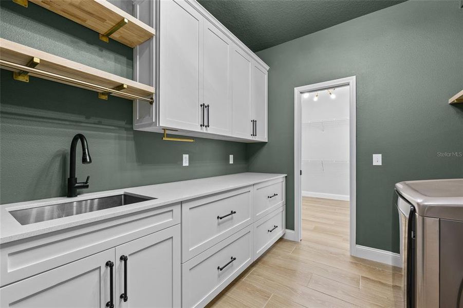 Laundry Room adjacent to primary walk-in closet