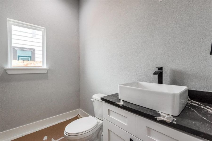 Bathroom featuring vanity and toilet