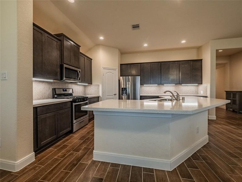 another view shows the coroner pantry which is very roomy ,you have recessed lighting, granite counter tops, stainless steel appliances