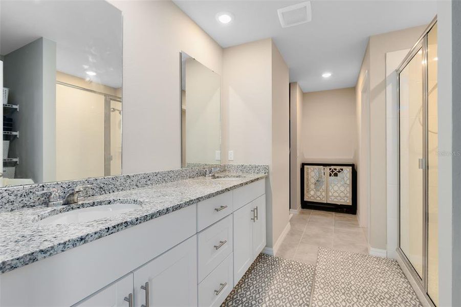 Primary Bathroom features double sink vanity with granite countertops, large walk in shower,private water room and large walkin closet