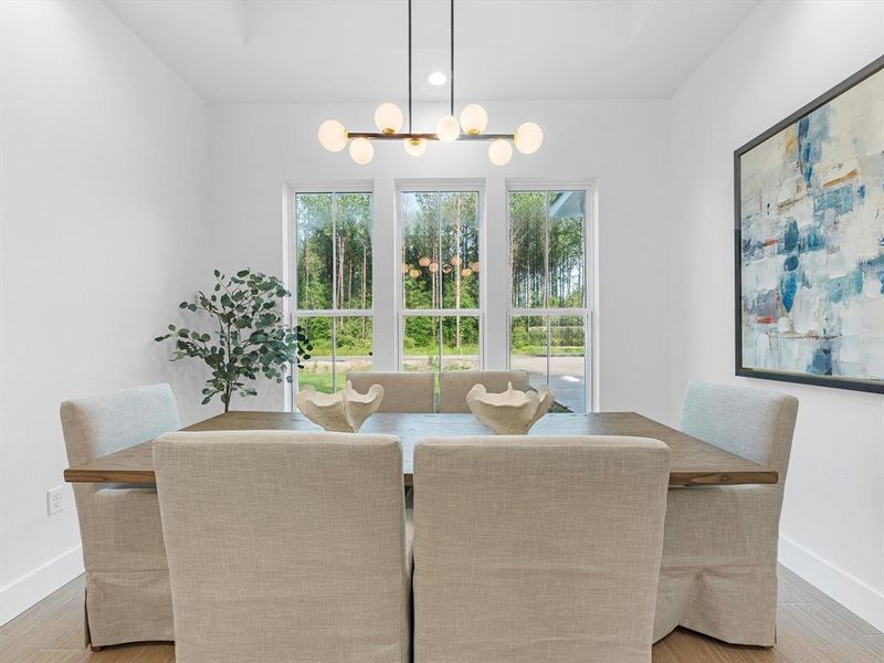 This formal dining space is perfectly sized, featuring large windows that enhance its ambiance.