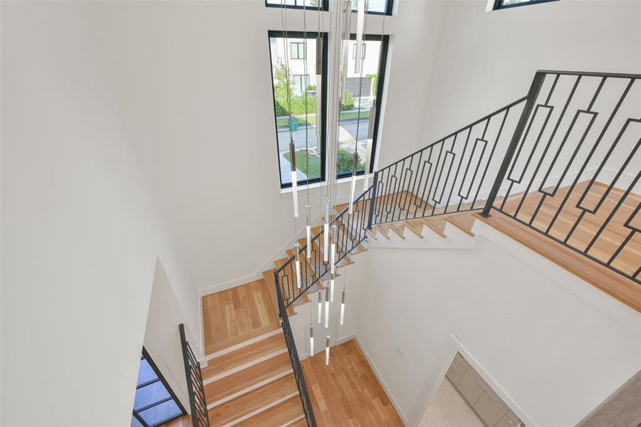 View from the top of the stairs. The long pendent chandelier Accents the two story entry.