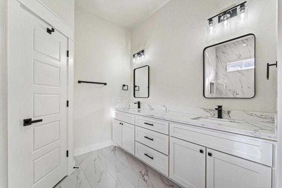 Wow what a view! Plenty of counter space and storage, as well as a  private water closet and dual mirrors and sinks.