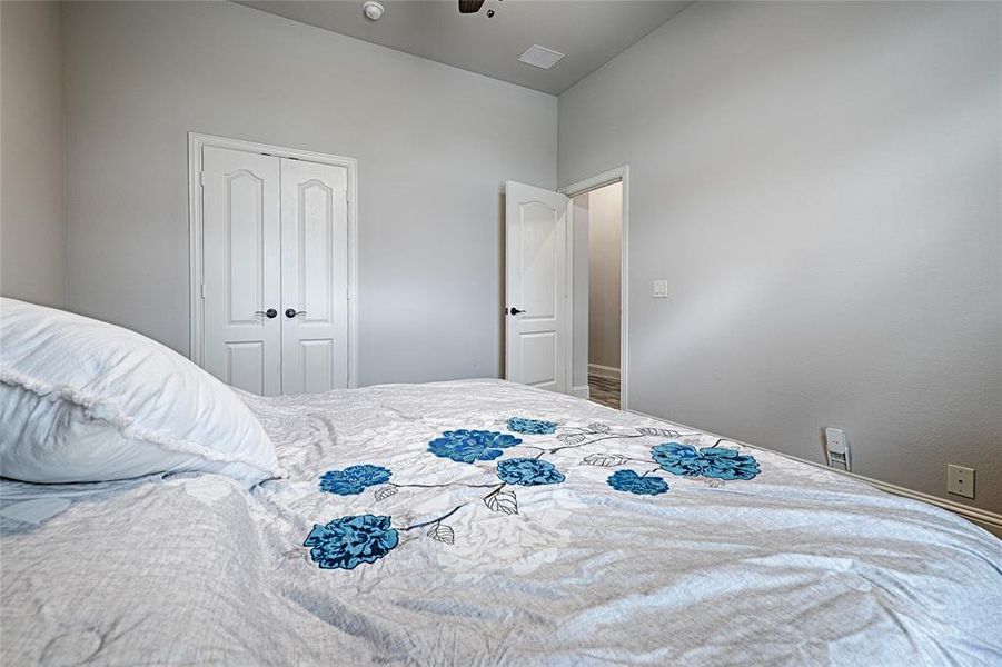 Bedroom featuring a closet, ceiling fan, and vaulted ceiling