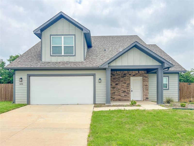 Craftsman-style house with a front yard