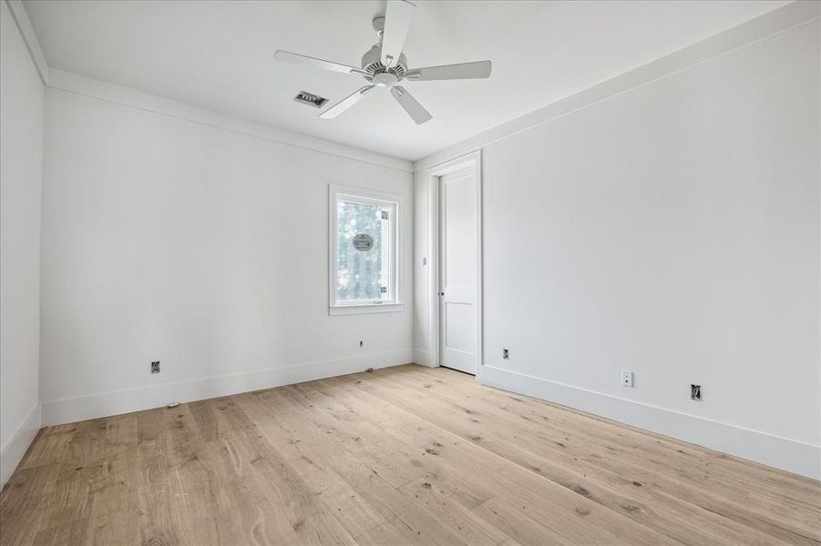 Secondary bedroom with hardwood floors, cased windows and recessed lighting. Large closet and ample natural light complete this space
