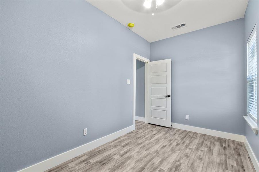 Spare room featuring ceiling fan and light hardwood / wood-style flooring