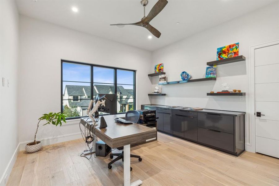 Office area featuring light wood-type flooring and ceiling fan