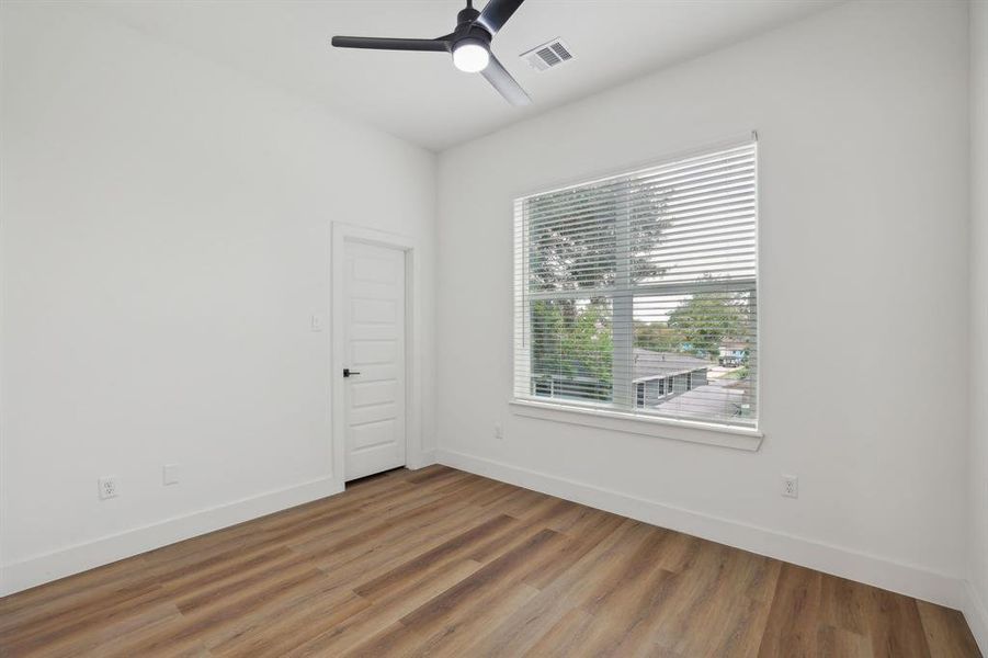 Secondary bedroom with  spacious closet and no carpet