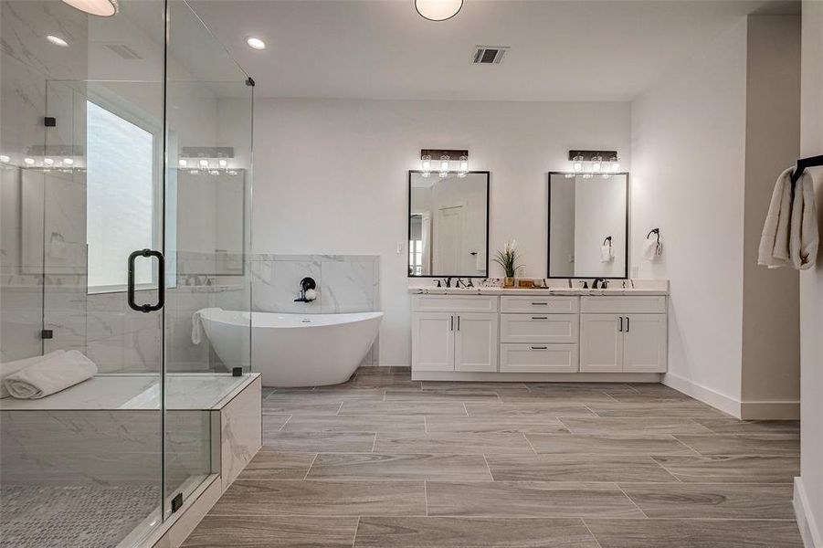 Spa-like Retreat, Primary En Suite, custom features, vanity with double sinks, shower with a seat and a soaking tub.