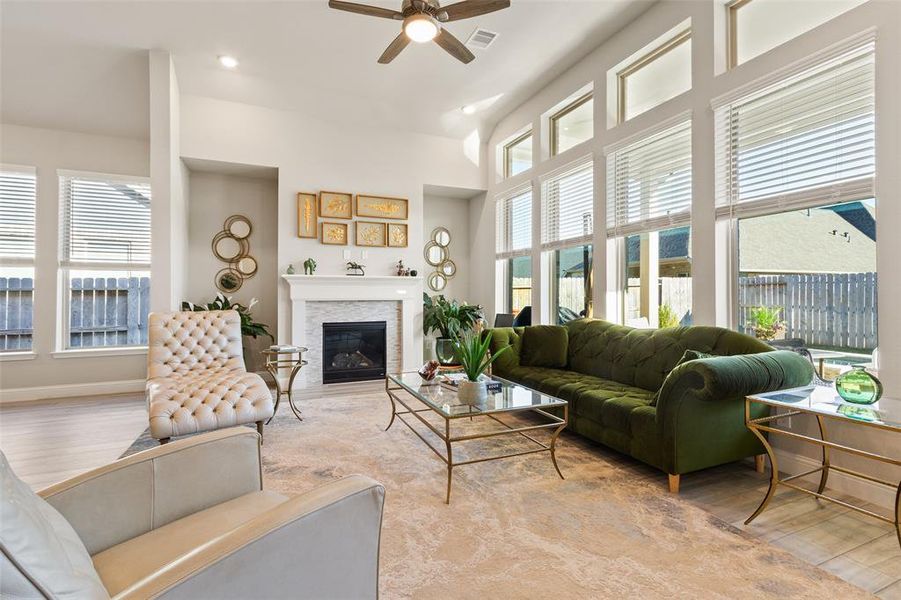 Chic stone fireplace anchoring a sunlit living space.