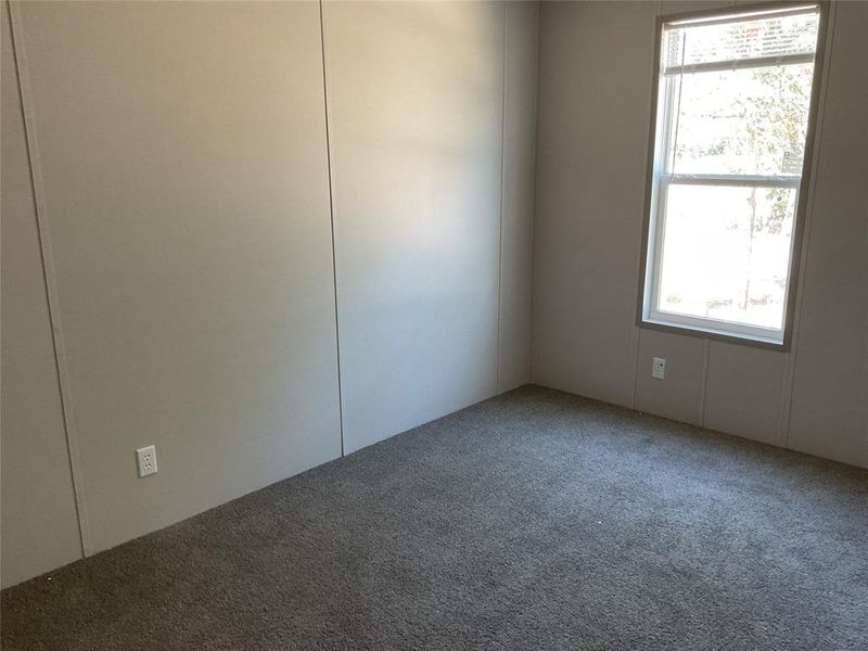 Carpeted empty room with plenty of natural light