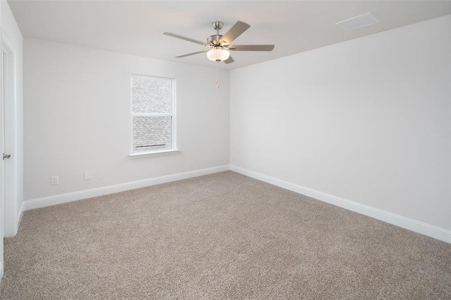 Unfurnished room featuring ceiling fan and carpet floors