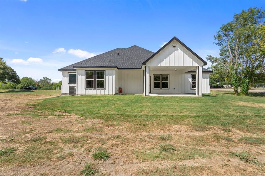 Back of house featuring a lawn