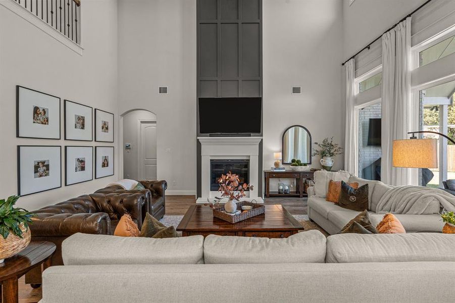 Living room featuring hardwood / wood-style flooring and a towering ceiling