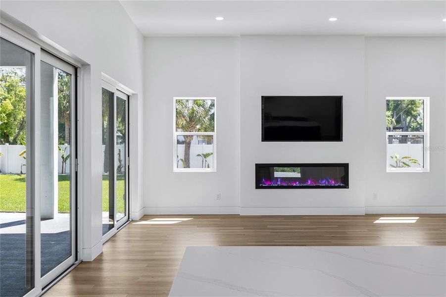 Living Room with Fireplace and two impact sliders