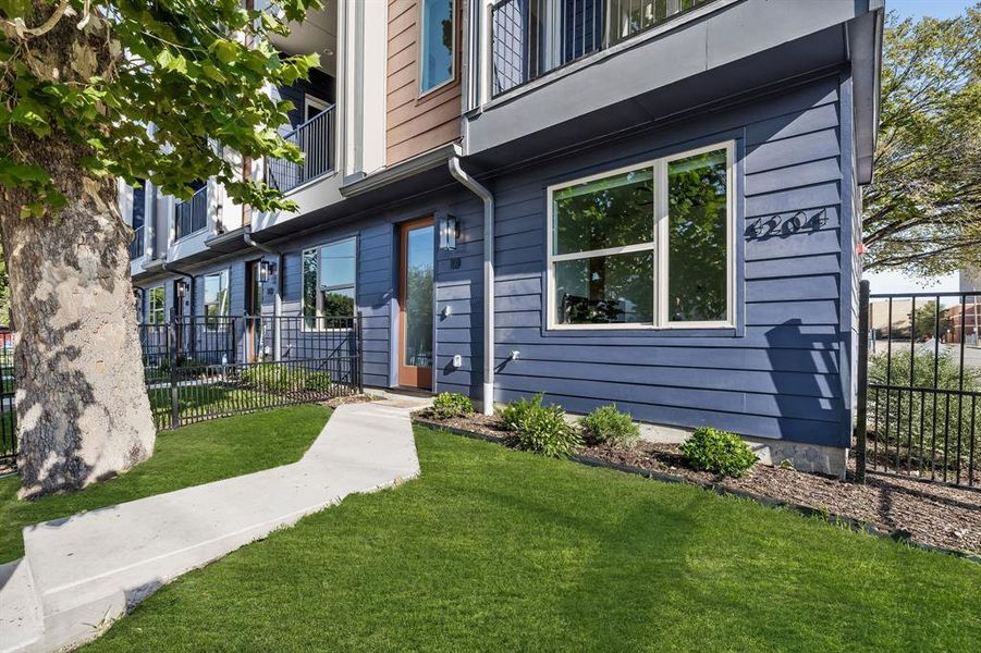 Entrance to property featuring a balcony and a gated yard