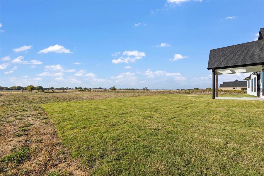 View of yard with a rural view