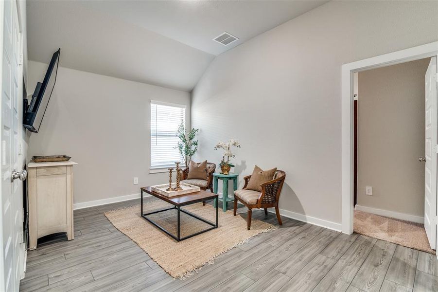 Living area featuring light hardwood / wood-style floors and lofted ceiling