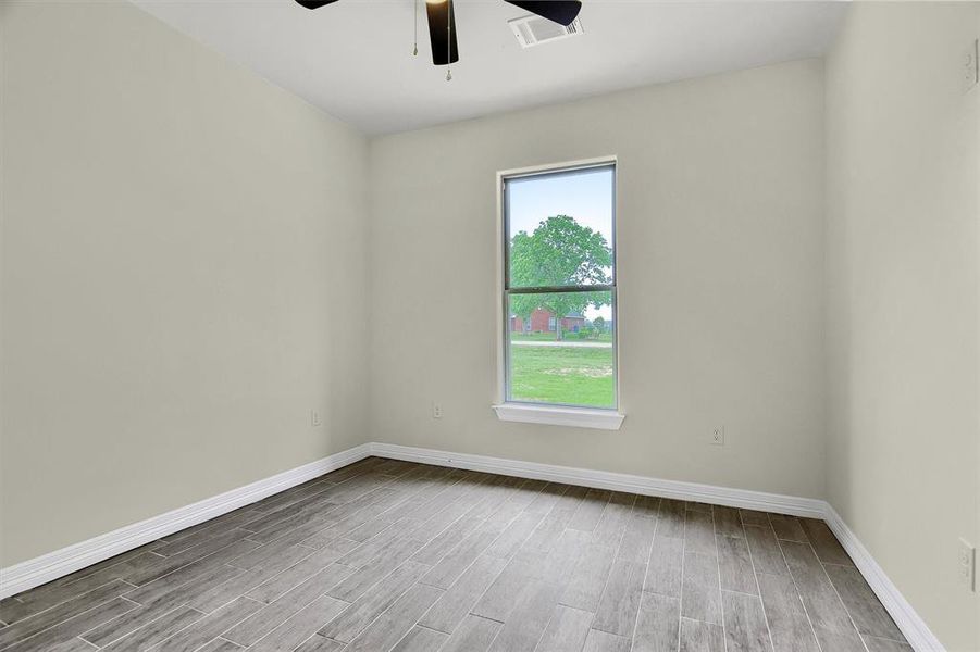 Bedroom featuring Tile Plank flooring, a wealth of natural light, and ceiling fan